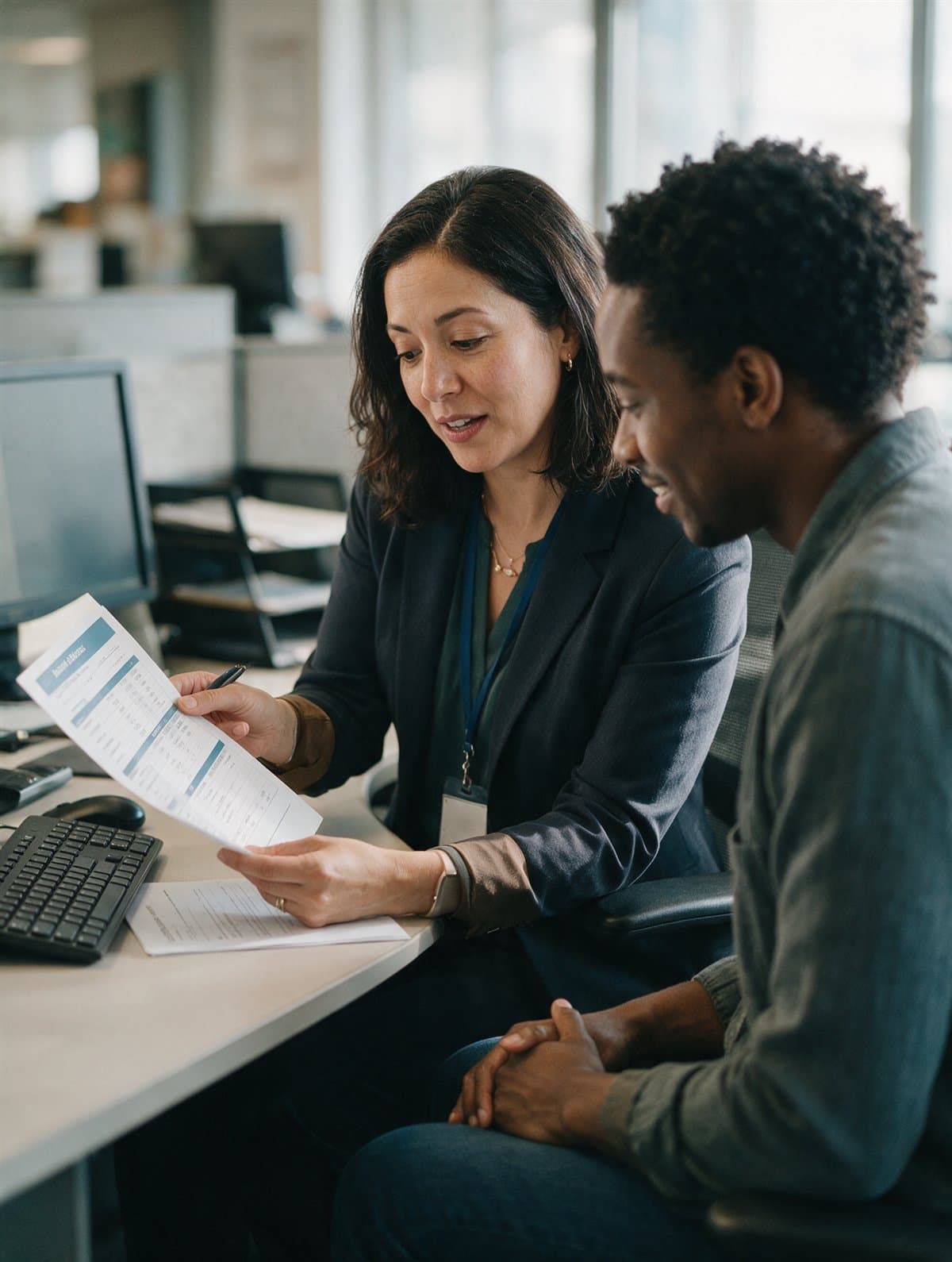 A benefits administrator walking an employee through a benefits summary